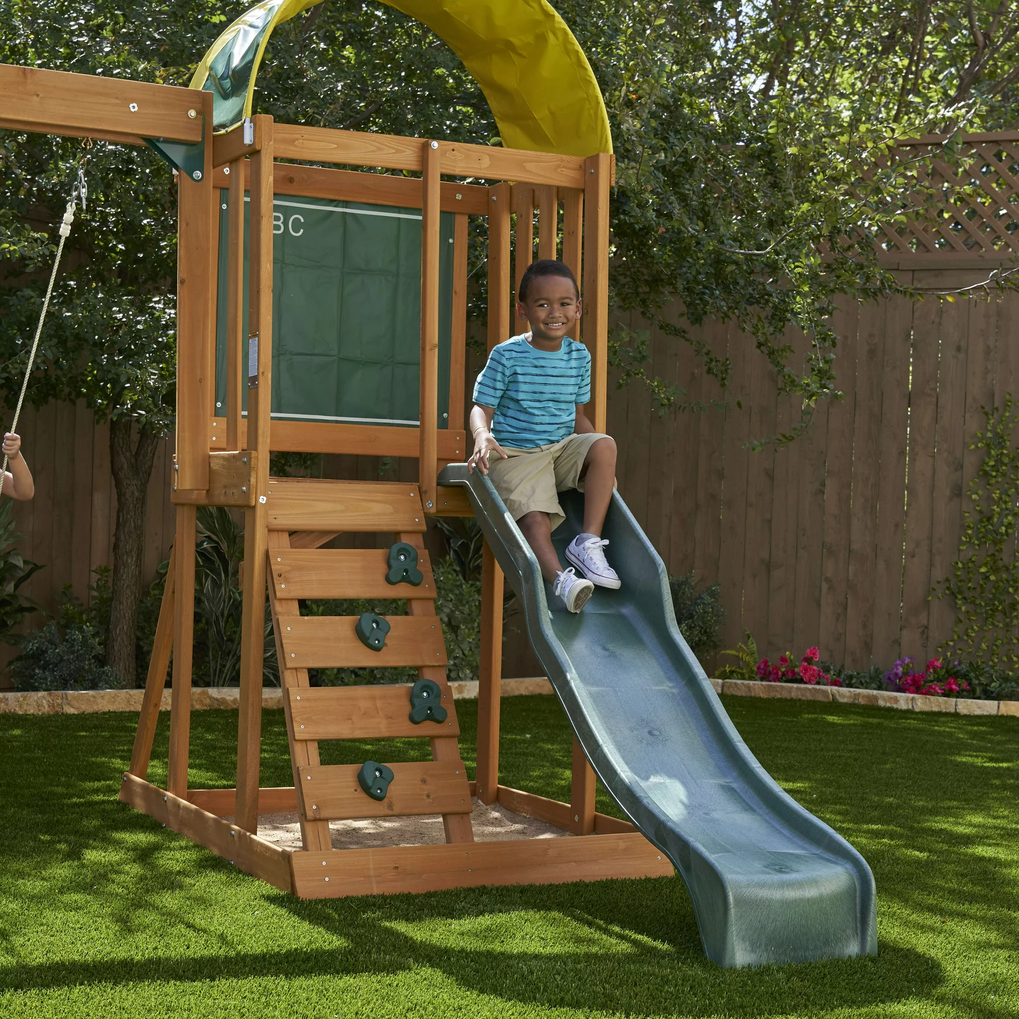 KidKraft Ainsley Wooden Outdoor Swing Set With Slide, Chalk Wall, Canopy And Rock Wall - Image 7